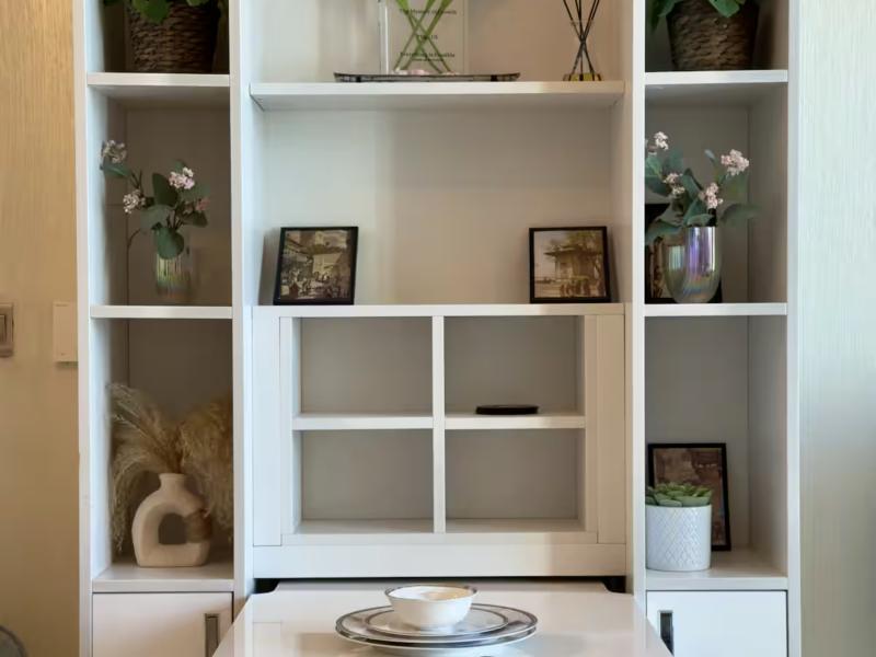 Styled shelves with plants and framed pictures